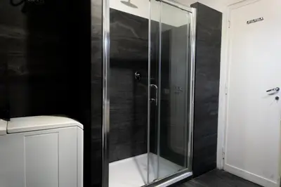 a shower with a glass door in a bathroom at Ermete Vatican House in Rome