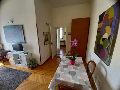 a living room with a table and a dining room at Casa Campo de' Fiori in Rome