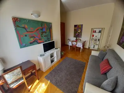 a living room with a couch and a flat screen tv at Casa Campo de' Fiori in Rome