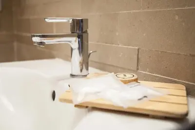 a bathroom sink with a faucet and a paper towel holder at St Peter's View in Rome