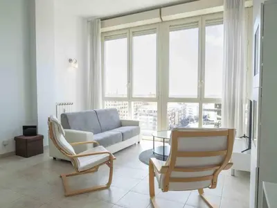 a living room with a couch and chairs and a table at Window on Rome in Rome