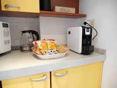a kitchen counter with a basket of bread and a coffee maker at Window on Rome in Rome