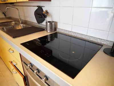 a kitchen counter with a stove and a sink at Window on Rome in Rome