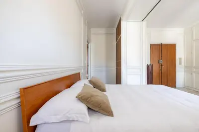 a bedroom with a bed with white sheets and pillows at White Suite in Rome in Rome