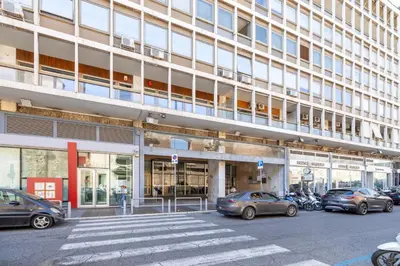 a parking lot with cars parked in front of a building at White Suite in Rome in Rome