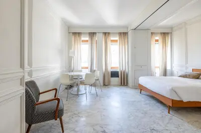 a bedroom with a bed and a table and chairs at White Suite in Rome in Rome