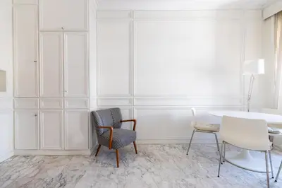 a white room with a chair and a table at White Suite in Rome in Rome