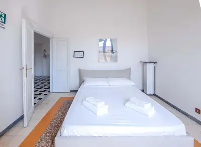 a large white bed in a white bedroom at EasyTopStay - Villa Borghese Large Apartment in Rome