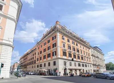 a large orange and white building on a city street at EasyTopStay - Villa Borghese Large Apartment in Rome