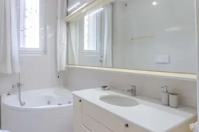 a bathroom with a sink and a tub and a mirror at EasyTopStay - Villa Borghese Large Apartment in Rome