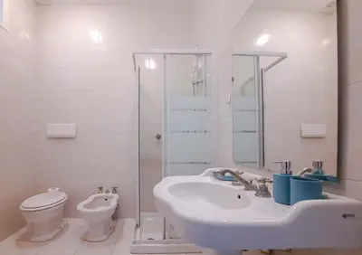 a white bathroom with a sink and a toilet at EasyTopStay - Villa Borghese Large Apartment in Rome