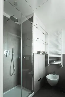 a bathroom with a shower and a toilet and a sink at EasyTopStay - Stylish Flat with Garden in Rome