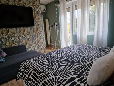 a bedroom with a black and white bed and a couch at Home K&Y Élite in Rome