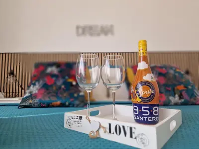 a bottle of beer and two wine glasses on a table at Home K&Y Élite in Rome