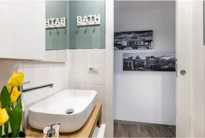 a bathroom with a white sink and a mirror at Home K&Y Élite in Rome