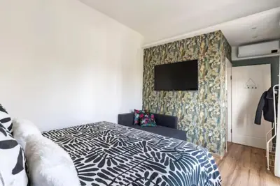 a bedroom with a bed and a tv on a wall at Home K&Y Élite in Rome