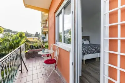 a balcony with a table and chairs and a bed at Home K&Y Élite in Rome