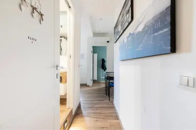 a hallway leading to a living room with a painting on the wall at Home K&Y Élite in Rome
