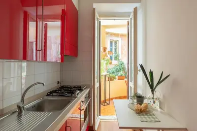 a kitchen with red cabinets and a sink at iFlat Red Roman Apartament in Rome
