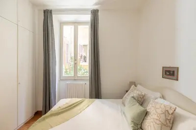 a bedroom with a white bed and a window at iFlat Red Roman Apartament in Rome