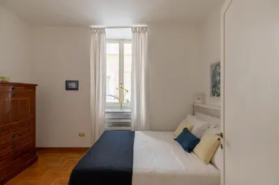 a bedroom with a bed and a window at iFlat Red Roman Apartament in Rome