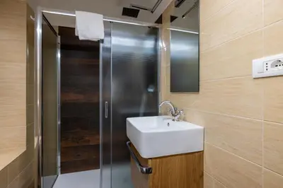 a bathroom with a sink and a shower at woodstyle apartment - navona in Rome