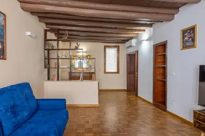 a living room with a blue couch and wooden floors at woodstyle apartment - navona in Rome