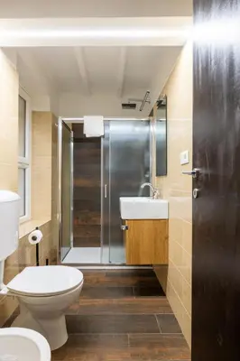 a bathroom with a toilet and a sink and a shower at woodstyle apartment - navona in Rome