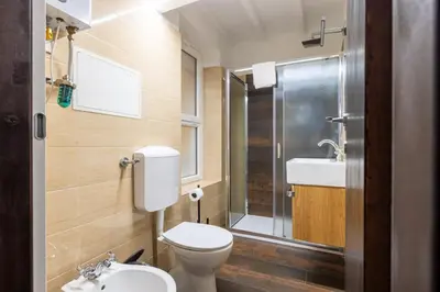 a bathroom with a toilet and a sink at woodstyle apartment - navona in Rome
