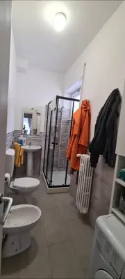 a bathroom with two sinks and two toilets at Home Rome Center in Rome