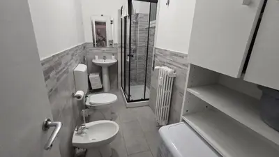 a bathroom with two toilets and a shower and a sink at Home Rome Center in Rome