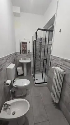 a bathroom with two toilets and a shower and a sink at Home Rome Center in Rome