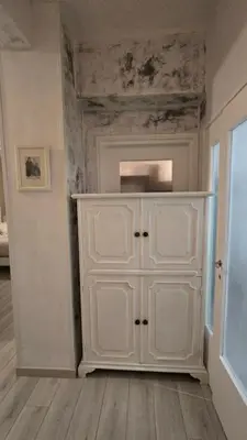 a white cabinet in the corner of a room at Home Rome Center in Rome