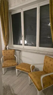 a room with two chairs and two windows at Home Rome Center in Rome