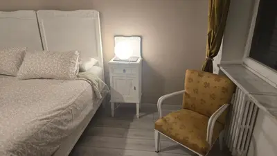 a bedroom with a bed and a chair and a lamp at Home Rome Center in Rome
