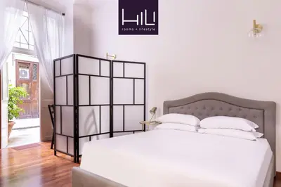 a bedroom with a large white bed with white pillows at Casa Salandra by Hili in Rome