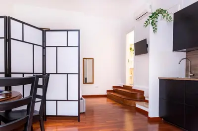 a living room with a kitchen and a dining room at Casa Salandra by Hili in Rome