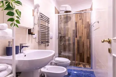 a bathroom with a sink and a toilet and a shower at Casa Salandra by Hili in Rome