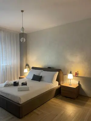 a bedroom with a large bed and two lamps at VATICAN HOME ROMA in Rome