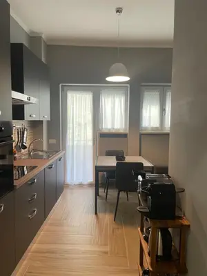 a kitchen with a table and a dining room at VATICAN HOME ROMA in Rome