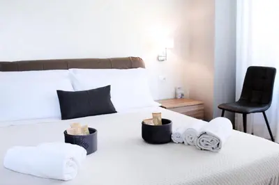 a bedroom with a bed with towels and a chair at VATICAN HOME ROMA in Rome