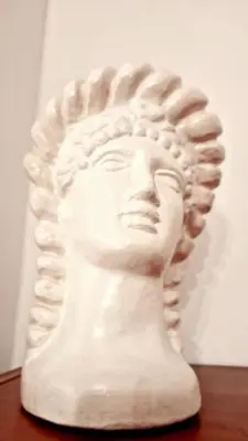 a white head statue sitting on top of a table at Giulia Home Apartment Metro Conca D'Doro Roma in Rome
