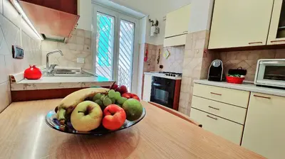 a bowl of fruit on a table in a kitchen at Giulia Home Apartment Metro Conca D'Doro Roma in Rome