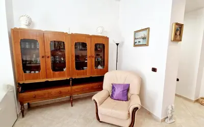 a chair with a purple pillow sitting in a room at Giulia Home Apartment Metro Conca D'Doro Roma in Rome