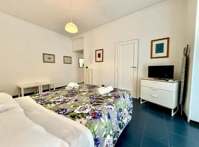 a bedroom with a bed and a dresser and a television at Ottaviano - 10 min dal Vaticano in Rome