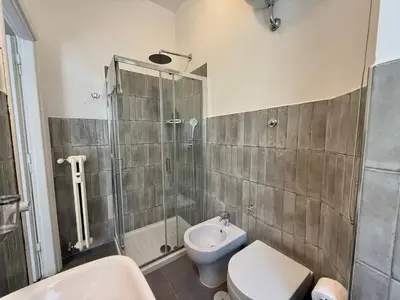 a bathroom with a shower and a toilet and a sink at Ottaviano - 10 min dal Vaticano in Rome