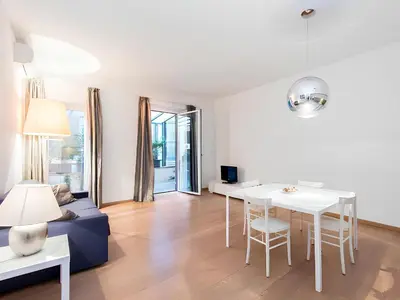 a living room with a couch and a table at The Apartment at Spanish Steps in Rome