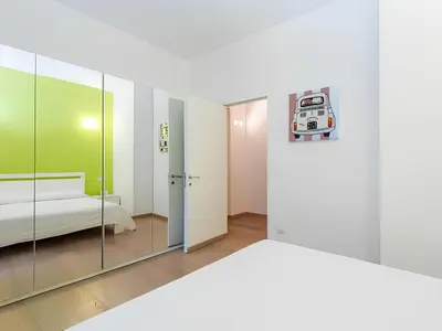 a room with a bed and a mirror at The Apartment at Spanish Steps in Rome