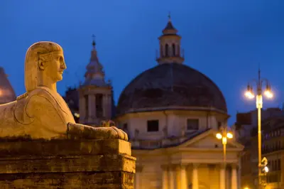 a statue of a man in front of a building at Tridente Suites in Rome