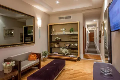 a living room with a couch and a large mirror at Tridente Suites in Rome